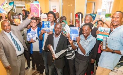 Riara University staff and students receiving the textbooks. 